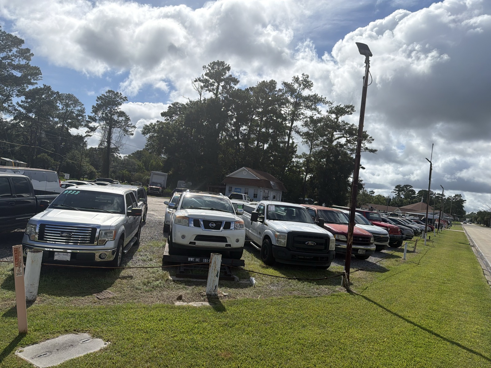 Row of trucks and SUVs for sale along Lopez Street